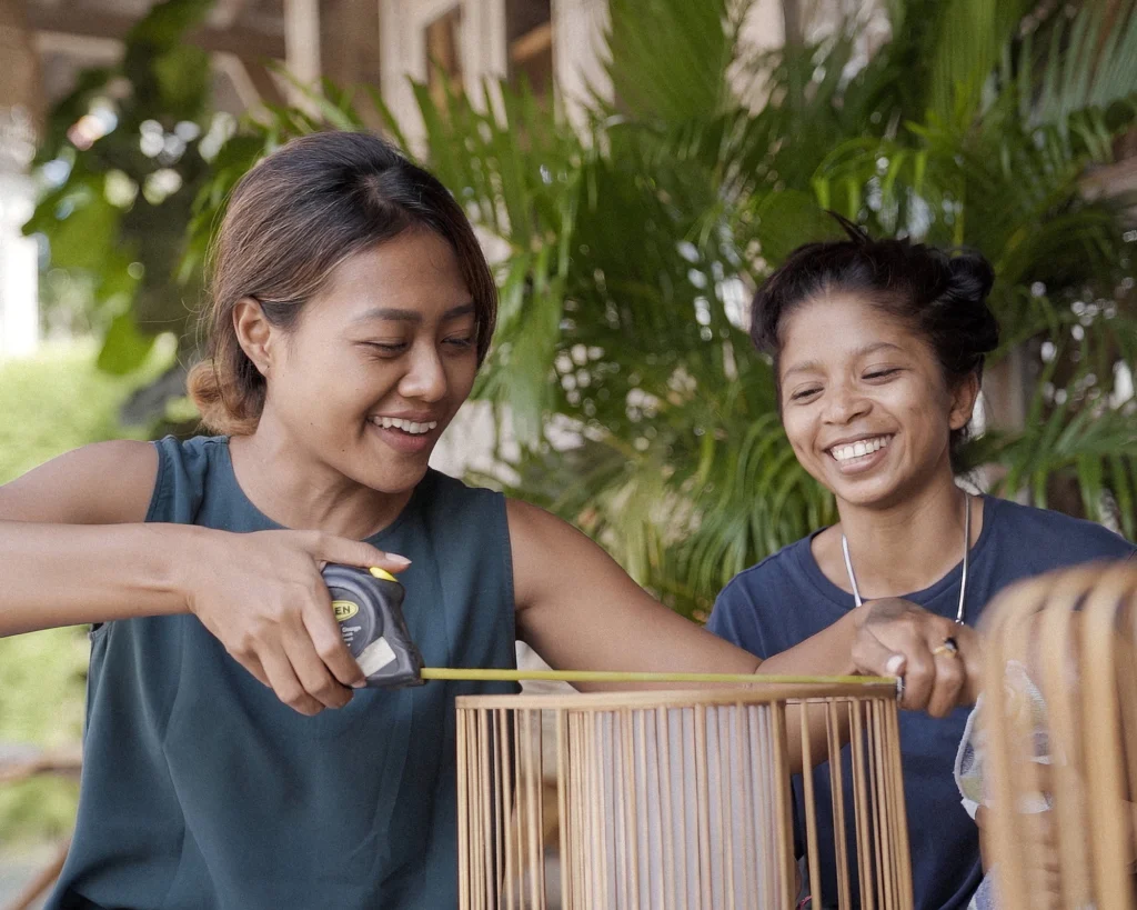 Nusantara Lifestyle co-founder Anysia measuring wood for one of their reclaimed teak designs.
