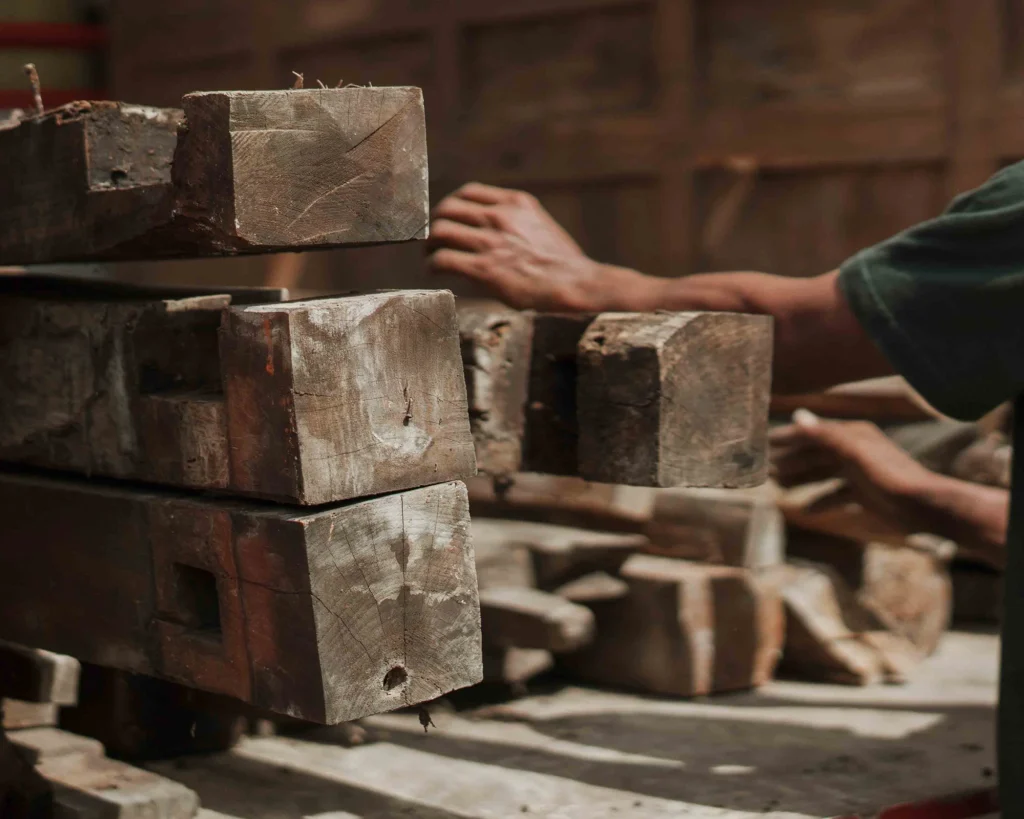 Close-up of weathered reclaimed teak wood with tight grain and aged tones.