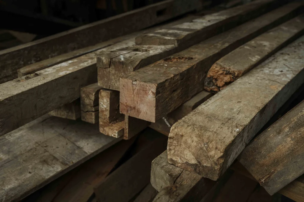 Reclaimed teak planks salvaged from old Javanese houses by Nusantara Lifestyle, ready for turning into furniture
