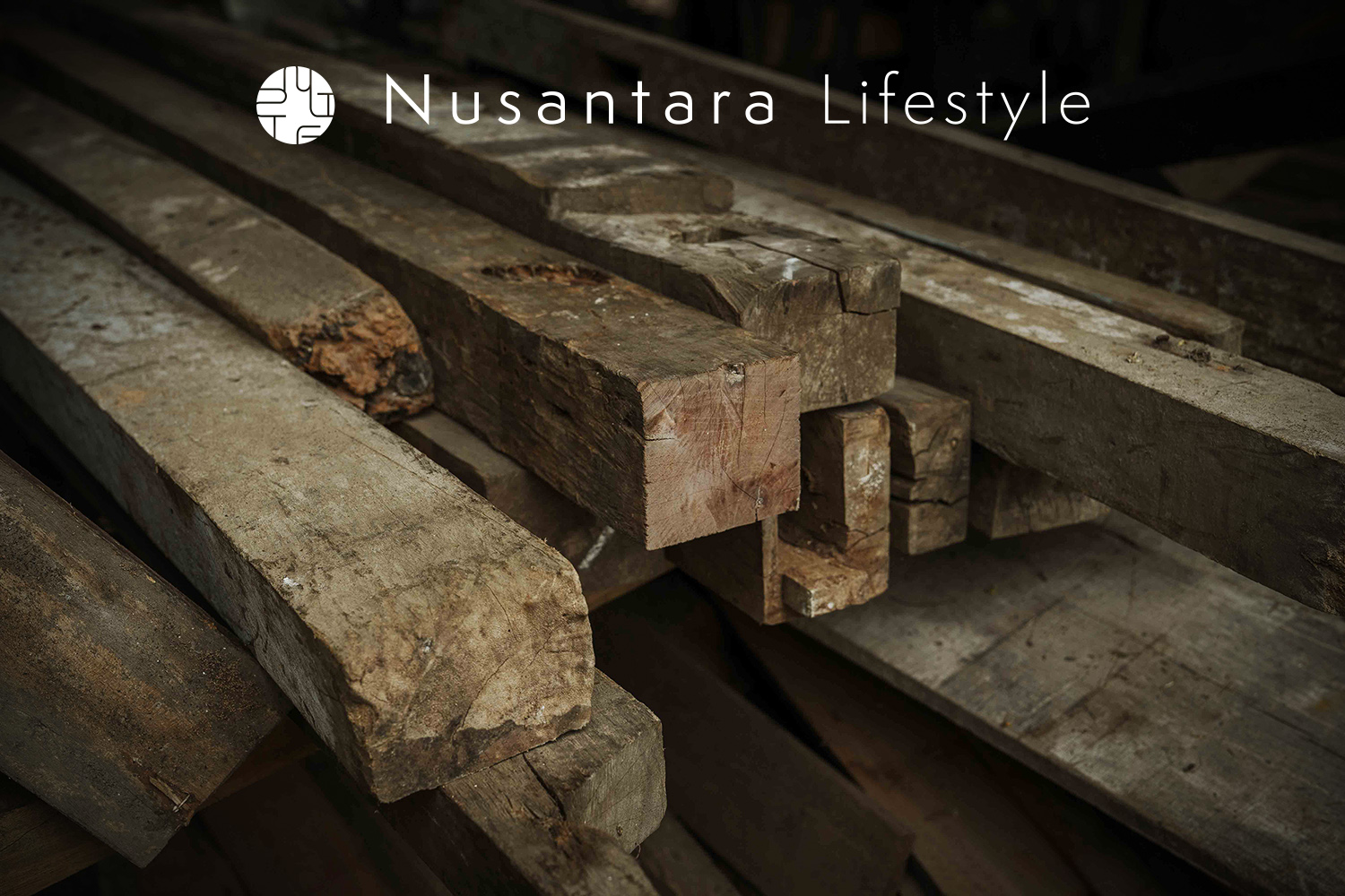 Stack of reclaimed teak wood beams salvaged from old Javanese houses, showcasing aged textures and natural patina, Nusantara Lifestyle