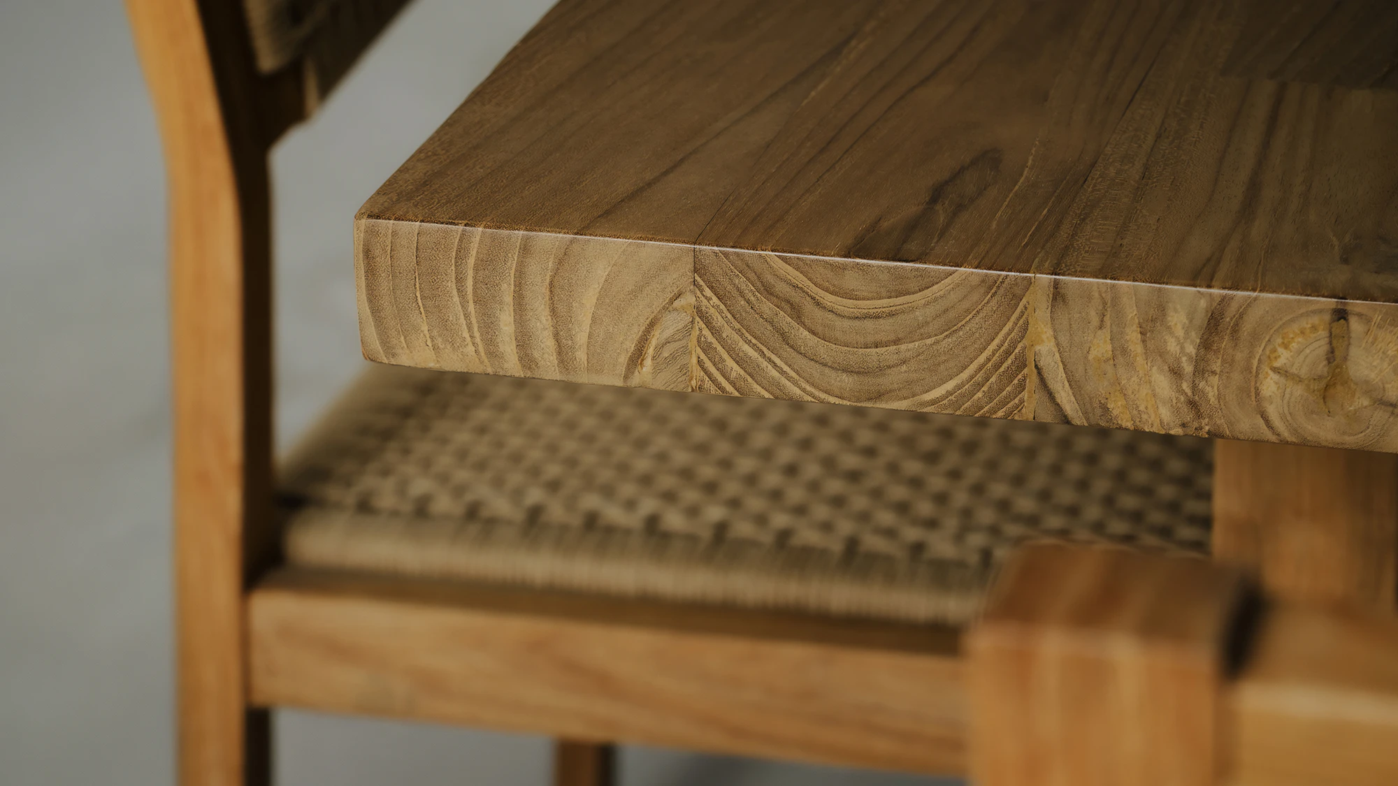 Close-up detail of reclaimed teak wood texture with natural patina and authentic material character by Nusantara Lifestyle.