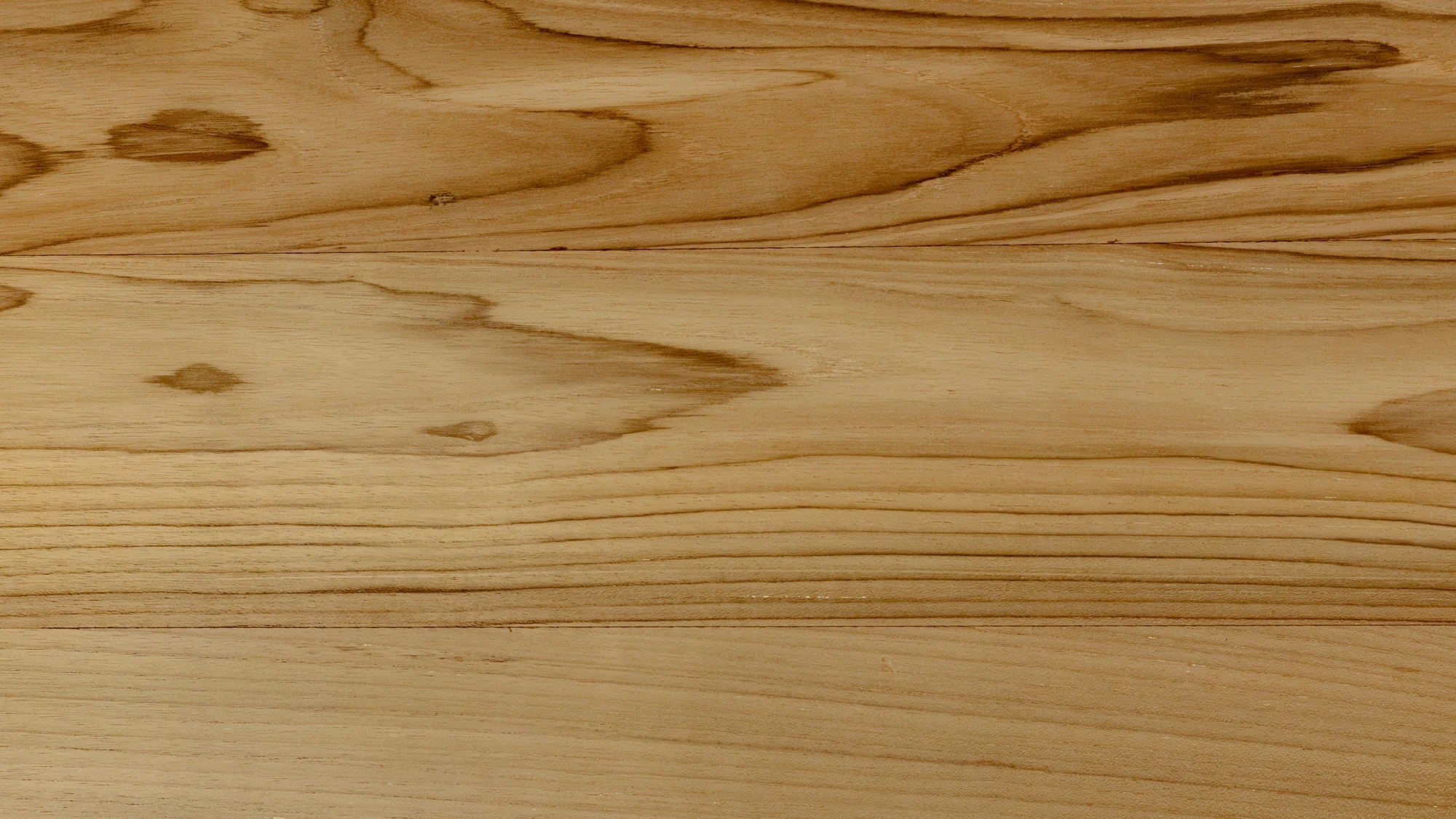 Close-up of reclaimed teak wood grain with natural tonal variation and organic texture by Nusantara Lifestyle.