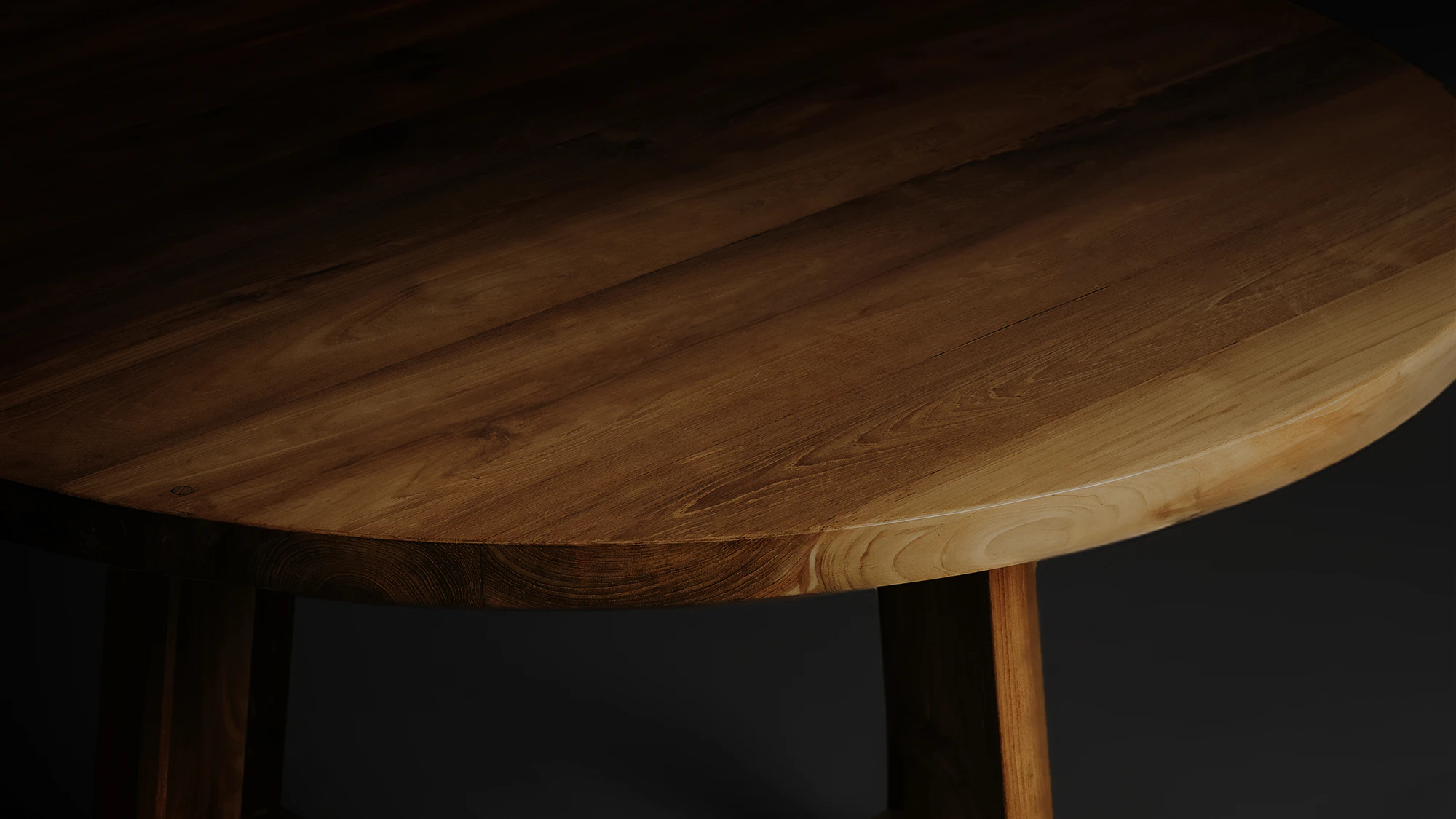 Round reclaimed teak dining table by Nusantara Lifestyle with rich wood tones and minimalist contemporary design.