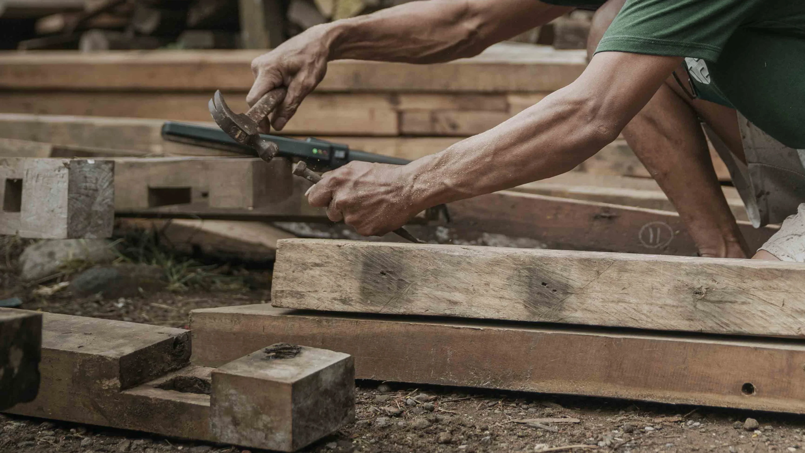 Skilled Indonesian craftsmen processing and assembling reclaimed teak furniture for Nusantara Lifestyle.