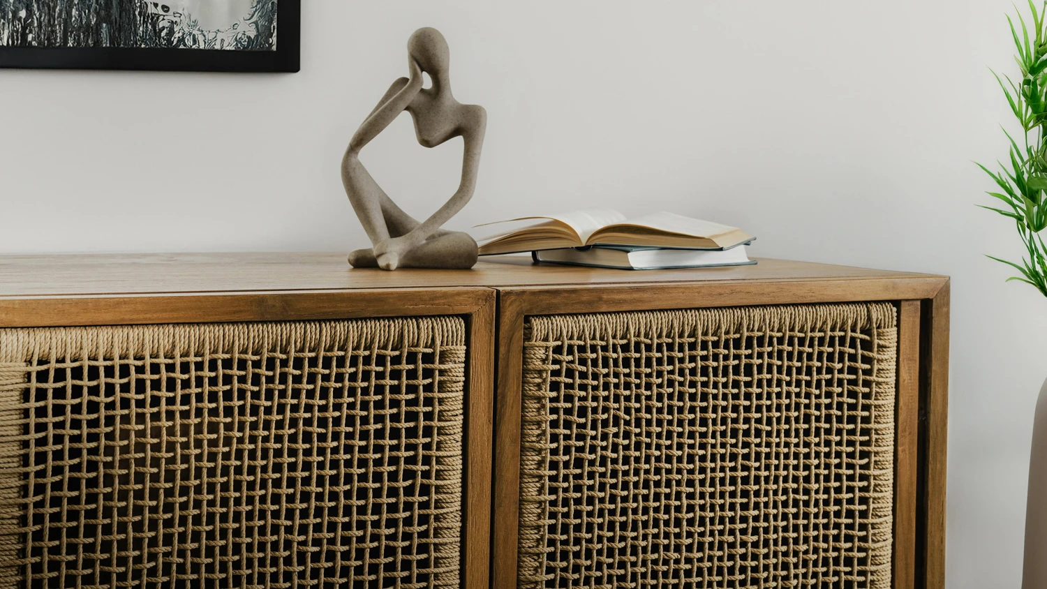 Natural teak cabinet with woven fiber panels, styled with minimalist decor in a warm and sustainable contemporary interior.