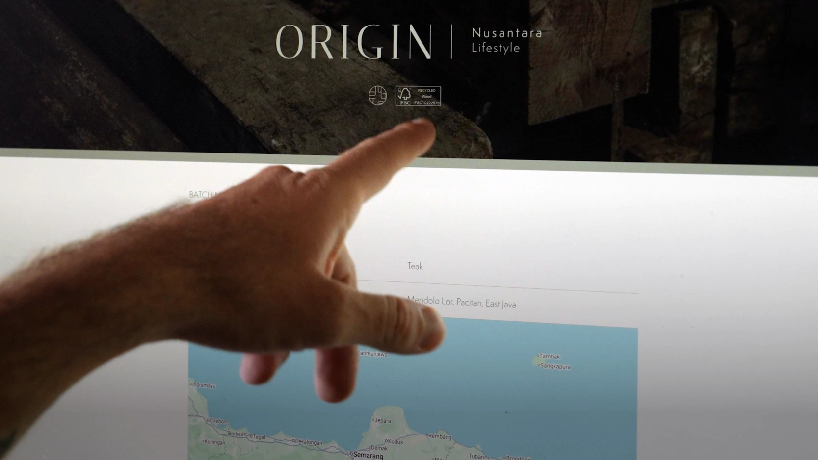 A person exploring Nusantara Lifestyle’s ORIGIN traceability platform, showing reclaimed teak provenance information and a map of its source location in East Java, Indonesia.